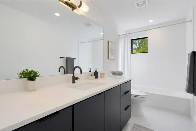 a bathroom with a double vanity sink and a bathtub