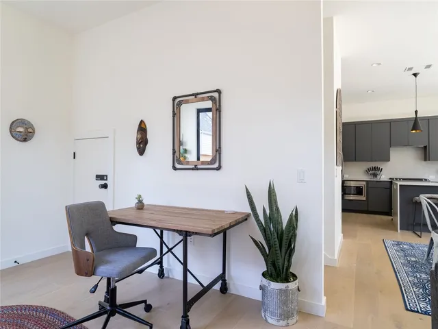 a view of a dining room with furniture and a potted plant