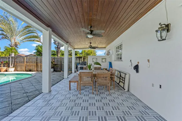 a view of a patio with a table chairs and a backyard