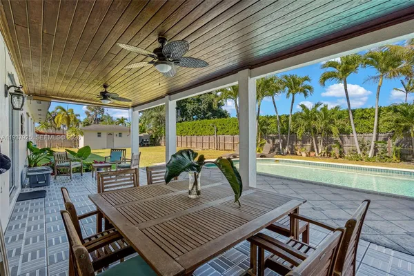 a view of a porch with furniture and a yard