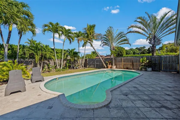 a view of a house with swimming pool having outdoor seating
