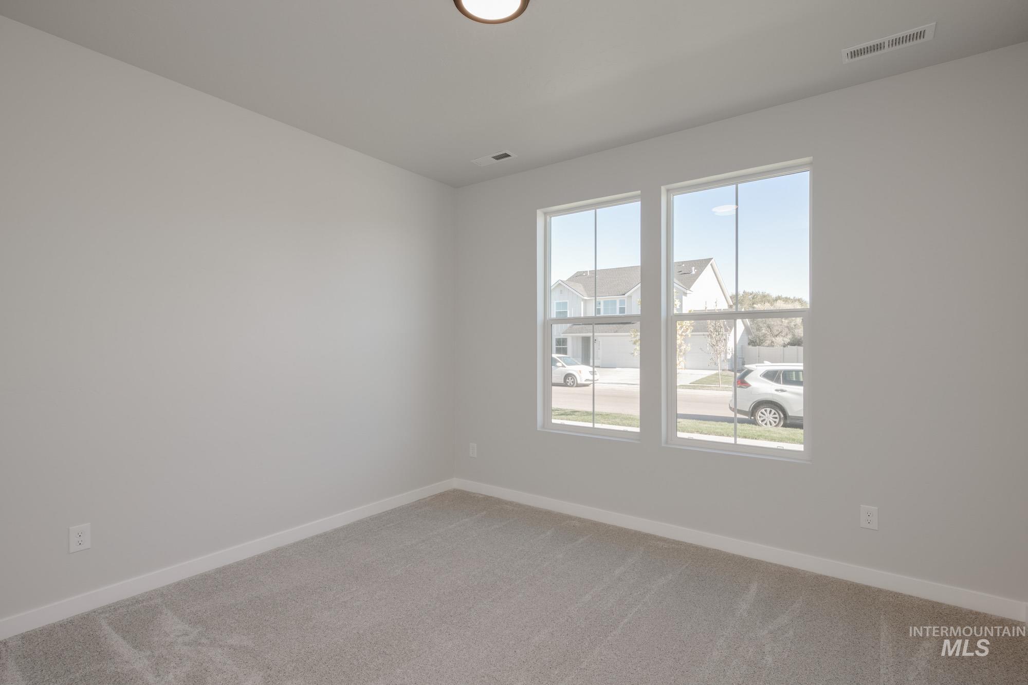 13731 Nisene Street Caldwell, ID 83607 - Photo 13 of 22 Empty room with baseboards and light carpet