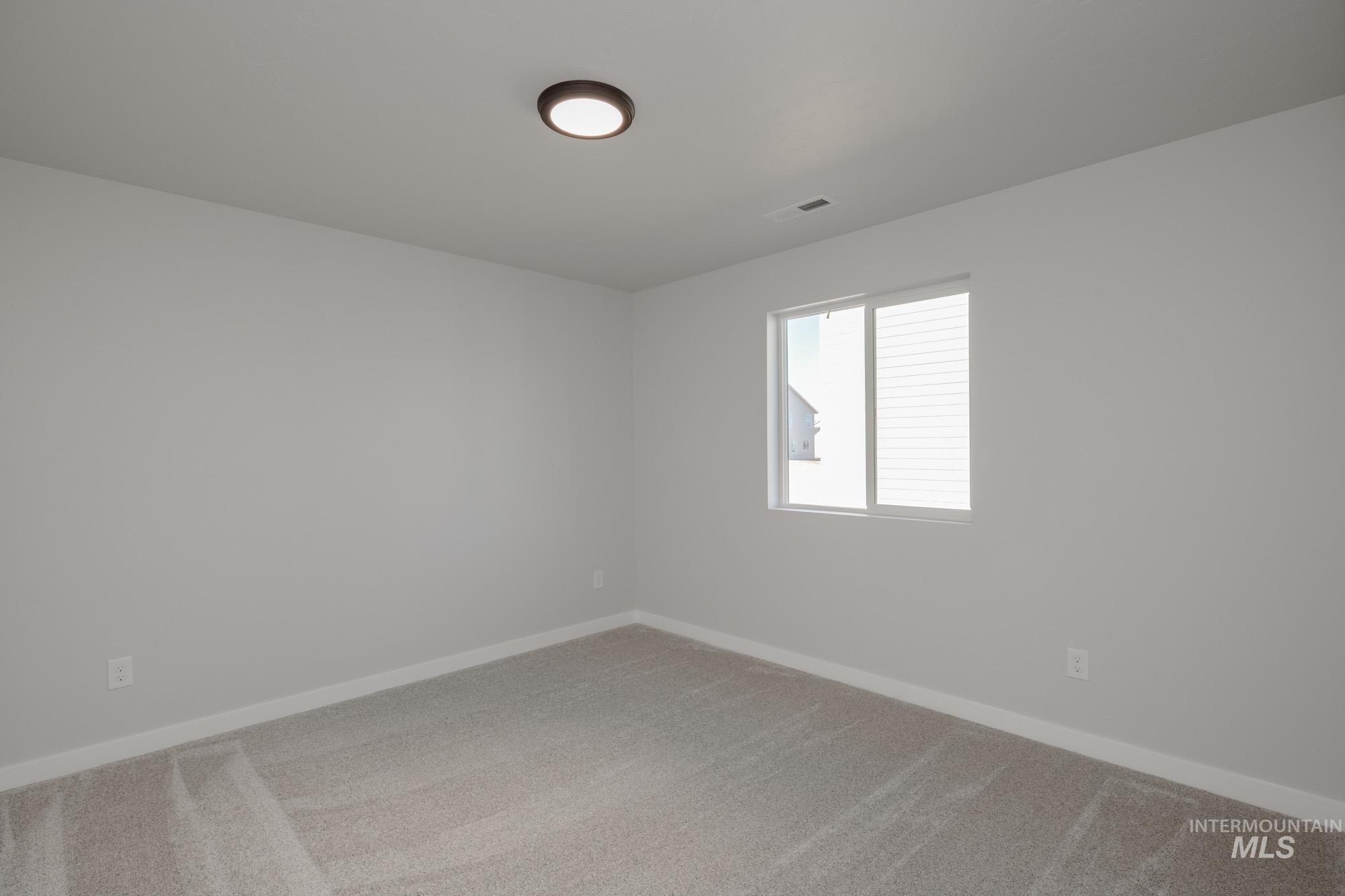 13731 Nisene Street Caldwell, ID 83607 - Photo 14 of 22 Spare room featuring light colored carpet