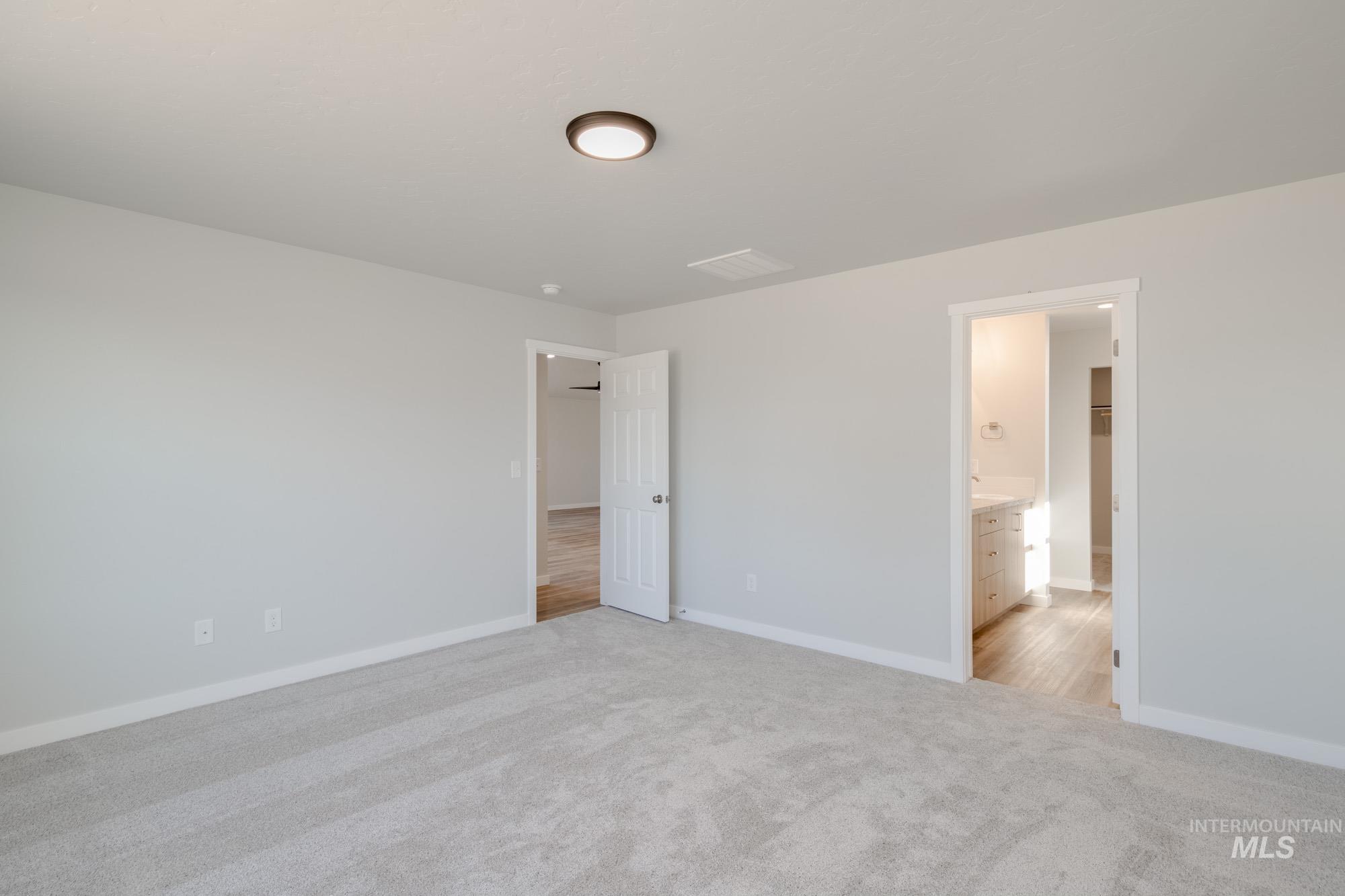 13731 Nisene Street Caldwell, ID 83607 - Photo 19 of 22 Unfurnished bedroom with light carpet and connected bathroom