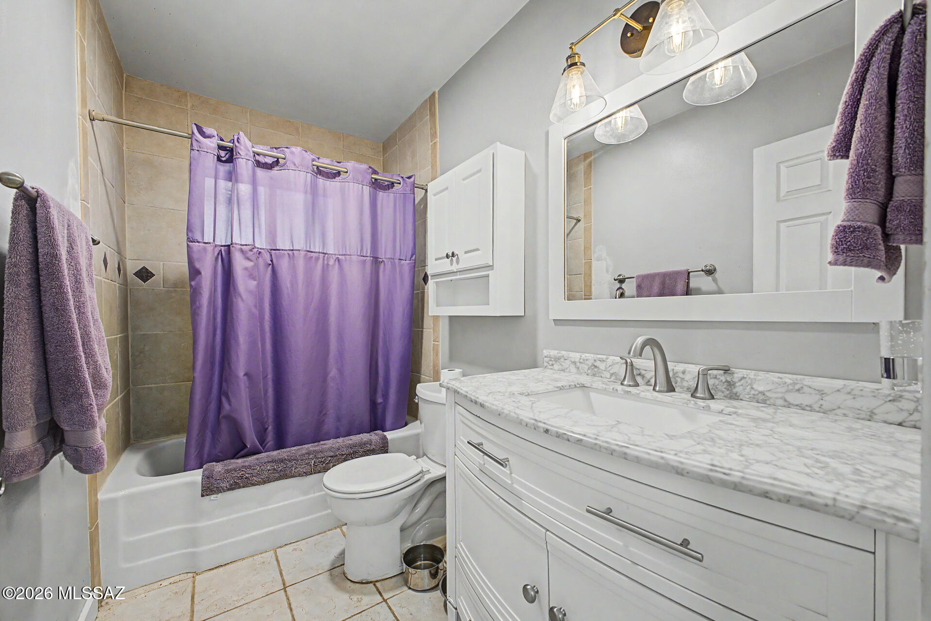 1172 East Allen Road Tucson, AZ 85719 - Photo 17 of 25 a bathroom with a granite countertop sink toilet mirror vanity and shower