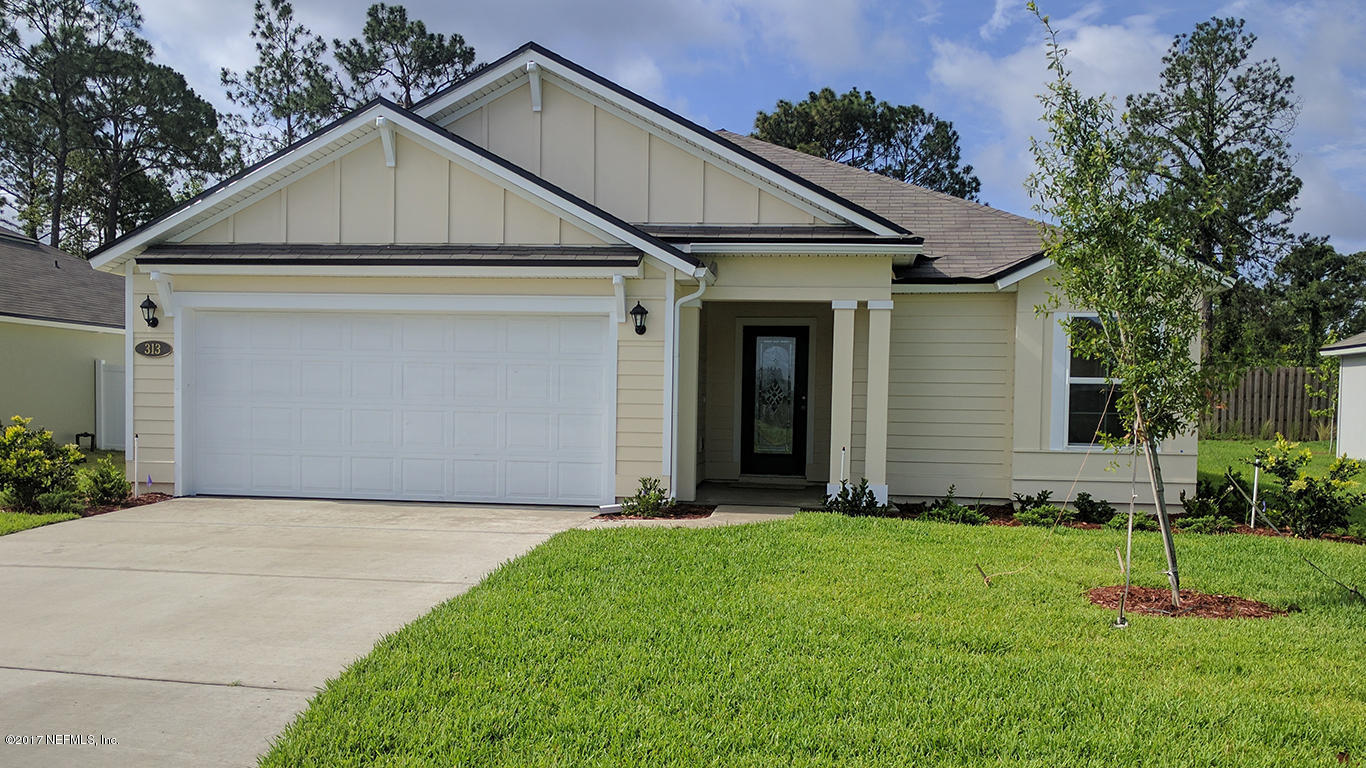 313 Deer Crossing Road St. Augustine, FL 32086 - Photo 1 of 11 a view of a white house next to a yard and large trees