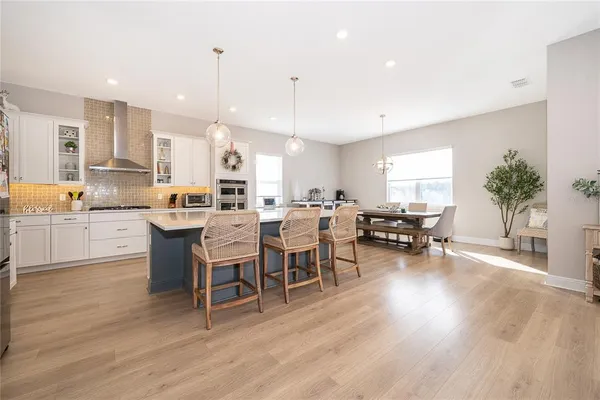 a large kitchen with a table and chairs in it
