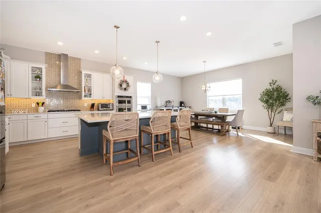 a large kitchen with a table and chairs in it