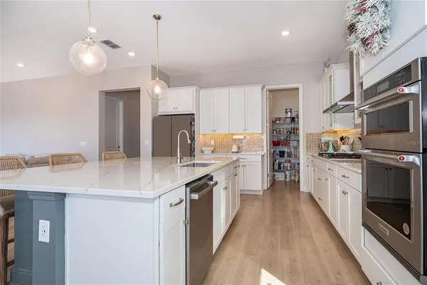 a kitchen with a stove and white cabinets