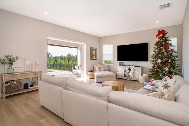 a view of a dining room with furniture and wooden floor