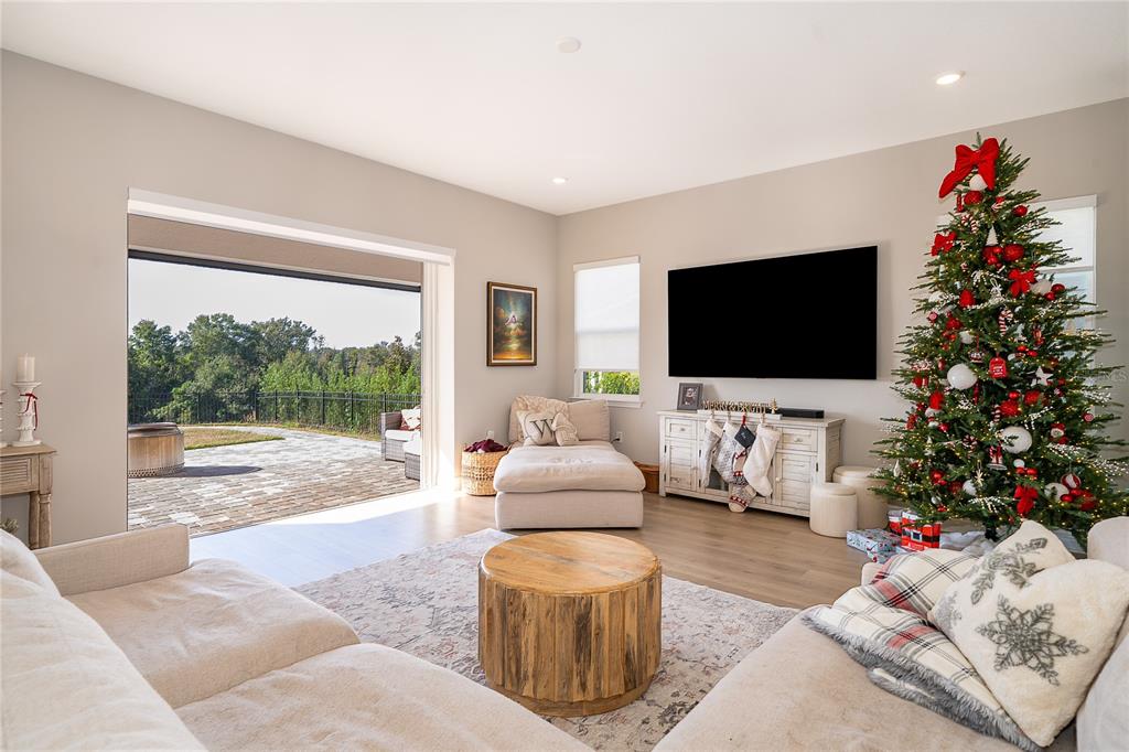 16033 Volterra Point Bella Collina, FL 34756 - Photo 22 of 54 a living room with furniture a flat screen tv and a large window