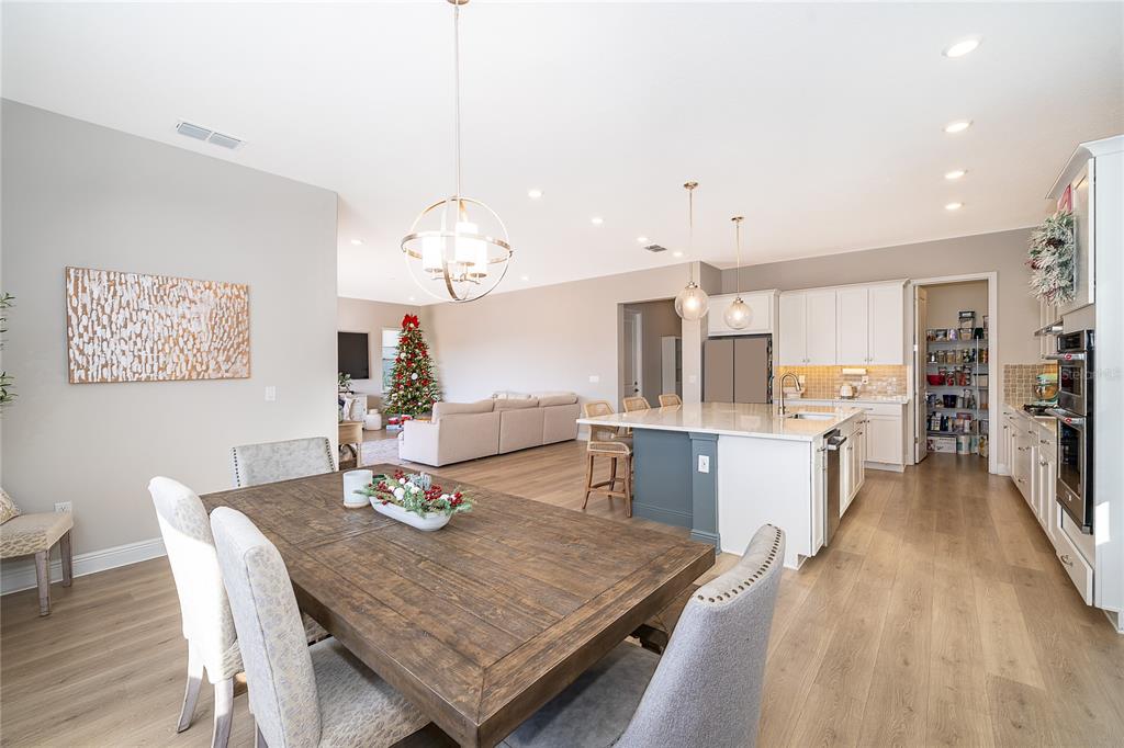 16033 Volterra Point Bella Collina, FL 34756 - Photo 23 of 54 a view of a dining room with furniture and wooden floor