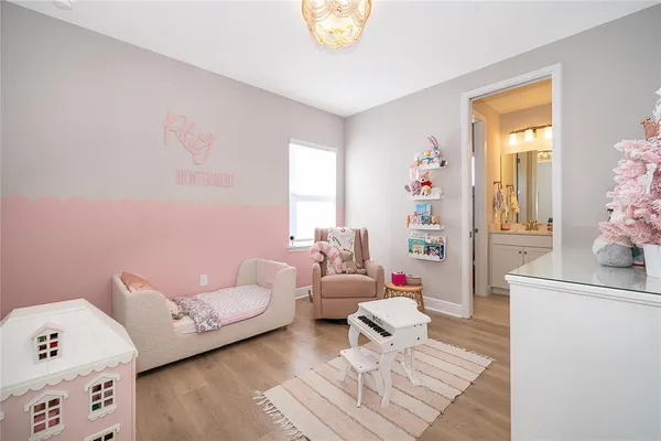 a living room with furniture a flat screen tv and a window