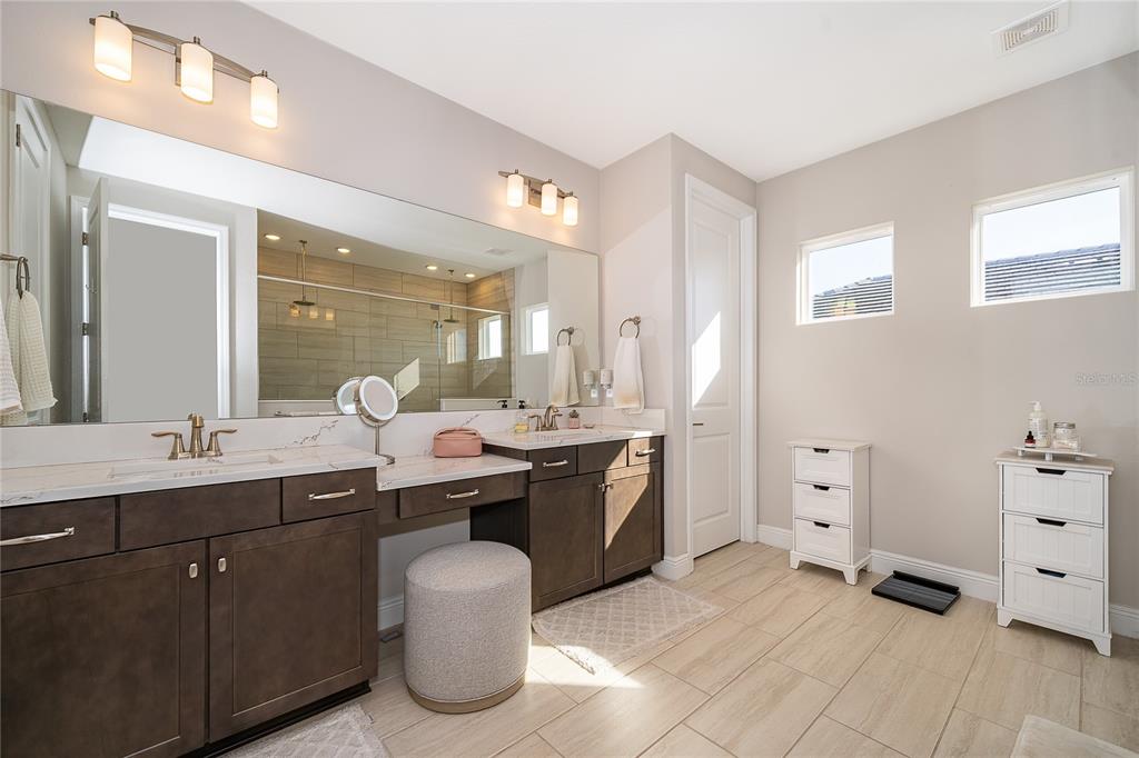 16033 Volterra Point Bella Collina, FL 34756 - Photo 27 of 54 a spacious bathroom with a granite countertop sink and a mirror