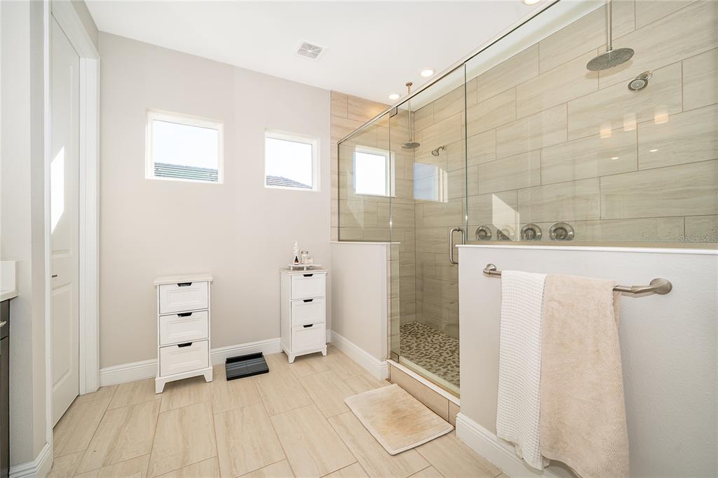 16033 Volterra Point Bella Collina, FL 34756 - Photo 28 of 54 a bathroom with a shower and a glass door