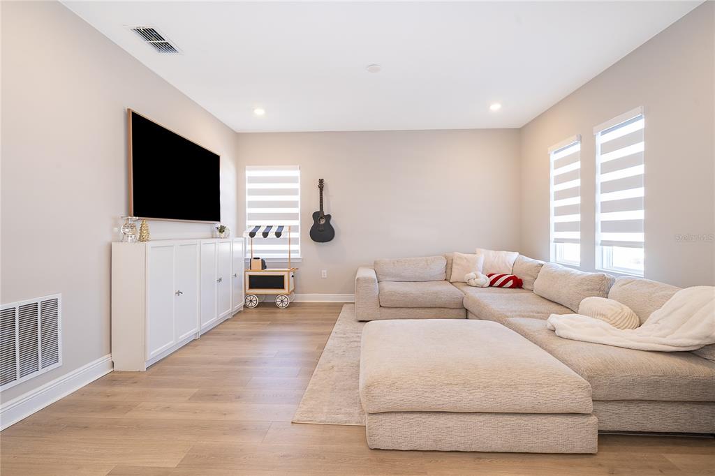 16033 Volterra Point Bella Collina, FL 34756 - Photo 31 of 54 a living room with furniture and a flat screen tv