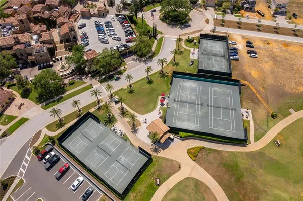 an aerial view of a house with swimming pool and lake view
