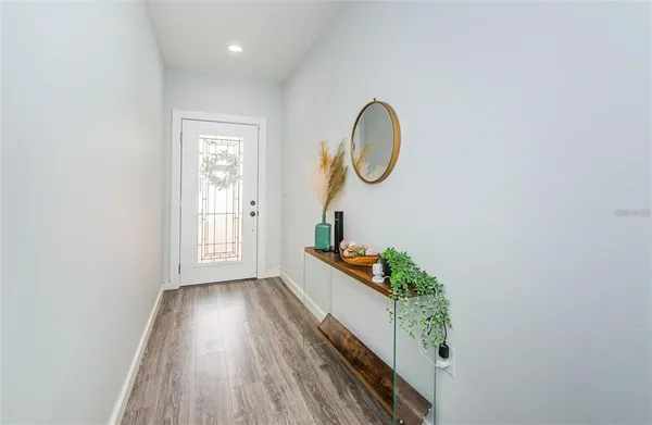 a room with wooden floor and entryway