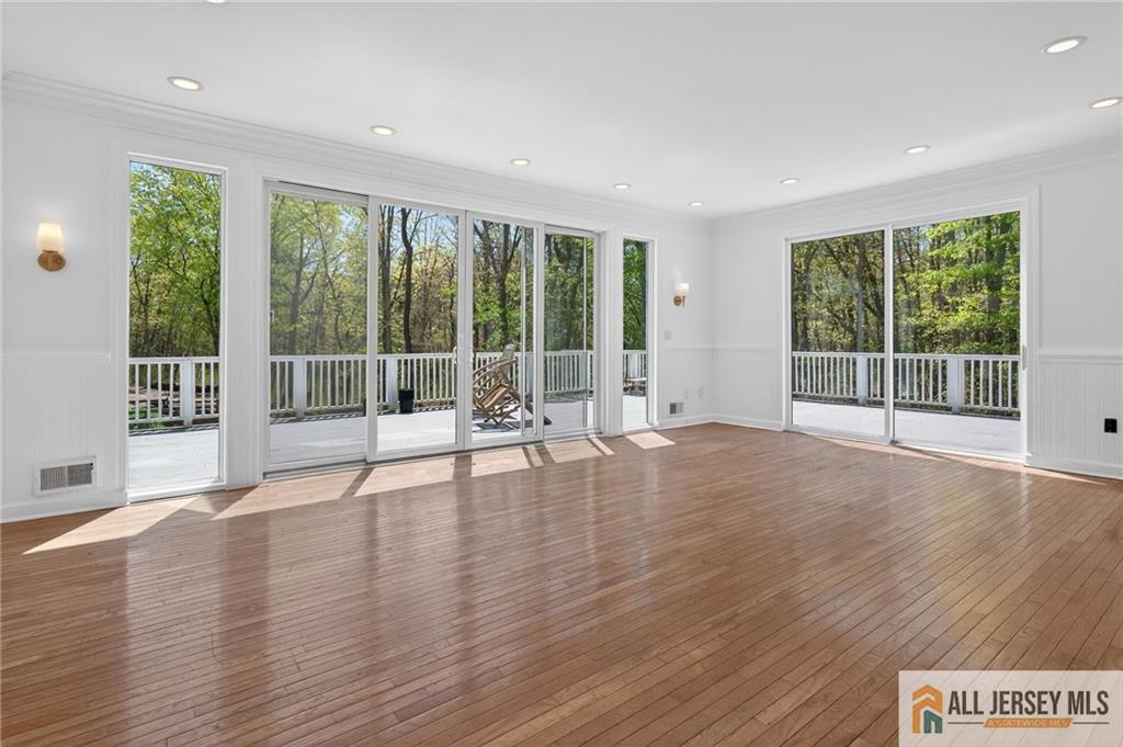 381 Monmouth Road Freehold, NJ 07728 - Photo 38 of 63 a view of an empty room with wooden floor and a window
