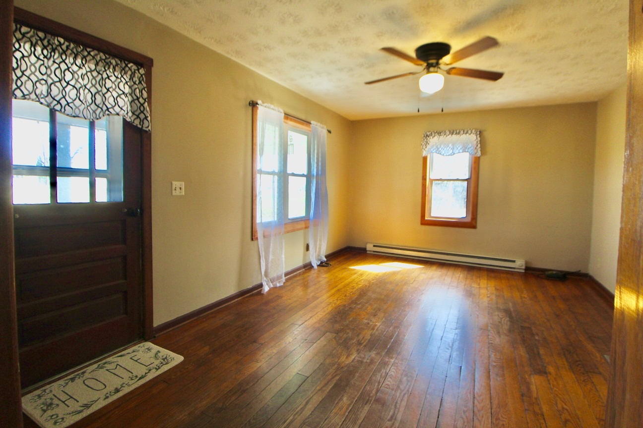 8862 Community Center Road Bridgewater, VA 22812 - Photo 19 of 29 a view of an empty room with a window and wooden floor