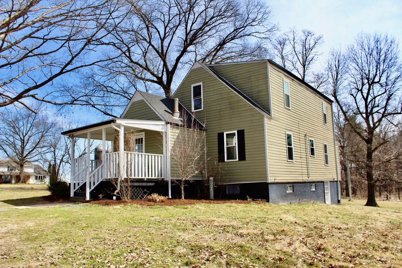 8862 Community Center Road Bridgewater, VA 22812 - Photo 8 of 29 a front view of a house with a yard covered in snow