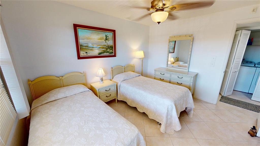 175 Kings Highway, Unit 736 Punta Gorda, FL 33983 - Photo 19 of 29 a bedroom with a bed and a chandelier