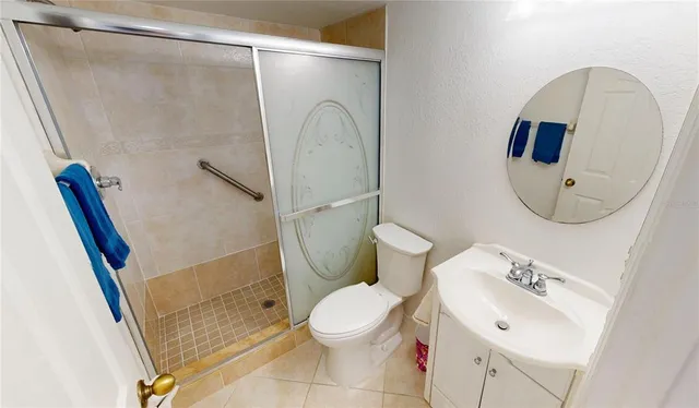 a bathroom with a sink mirror vanity and toilet