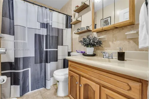 a bathroom with a sink a toilet and a shower