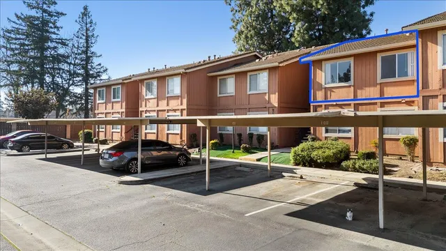 a view of a cars park in front of a building