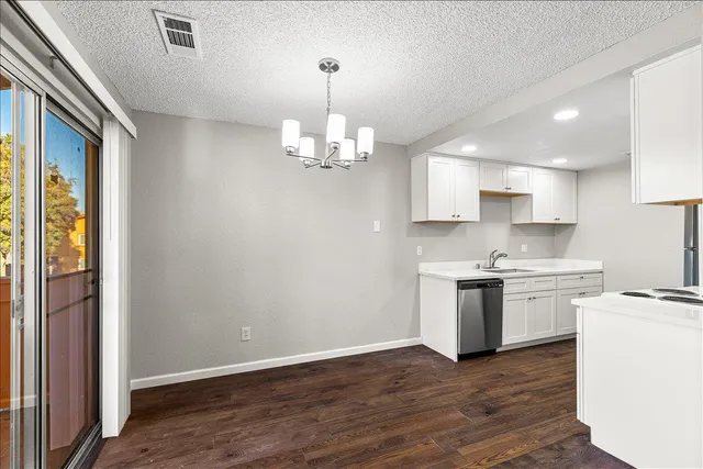 a kitchen with a stove a sink and a refrigerator