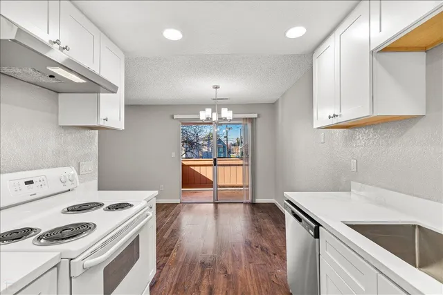 a kitchen with a stove a sink and a refrigerator