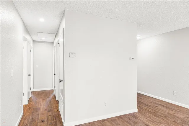 a view of hallway with wooden floor