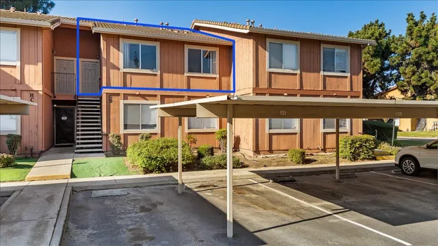 a view of a building with car parked