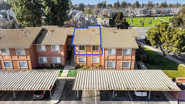 a view of a brick house with many windows