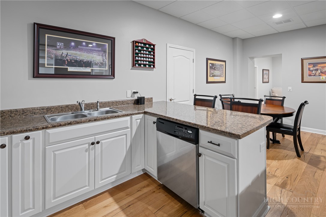 147 Riverside Park Court, Unit G2 Jefferson, NC 28640 - Photo 30 of 44 a kitchen with granite countertop a sink and cabinets