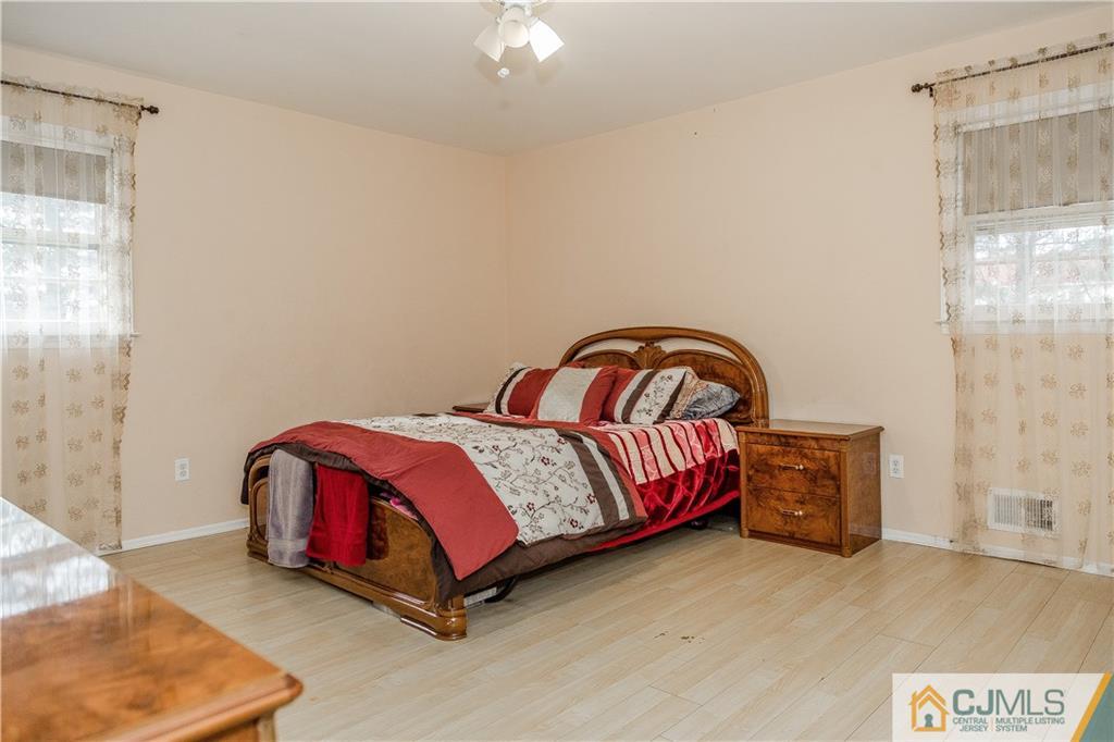 12 Crest Road East Brunswick, NJ 08816 - Photo 13 of 30 a bath room with a bed and a dresser