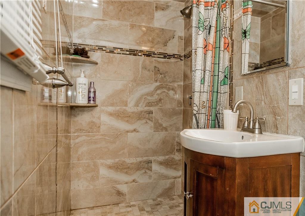 12 Crest Road East Brunswick, NJ 08816 - Photo 15 of 30 a bathroom with a sink and a mirror