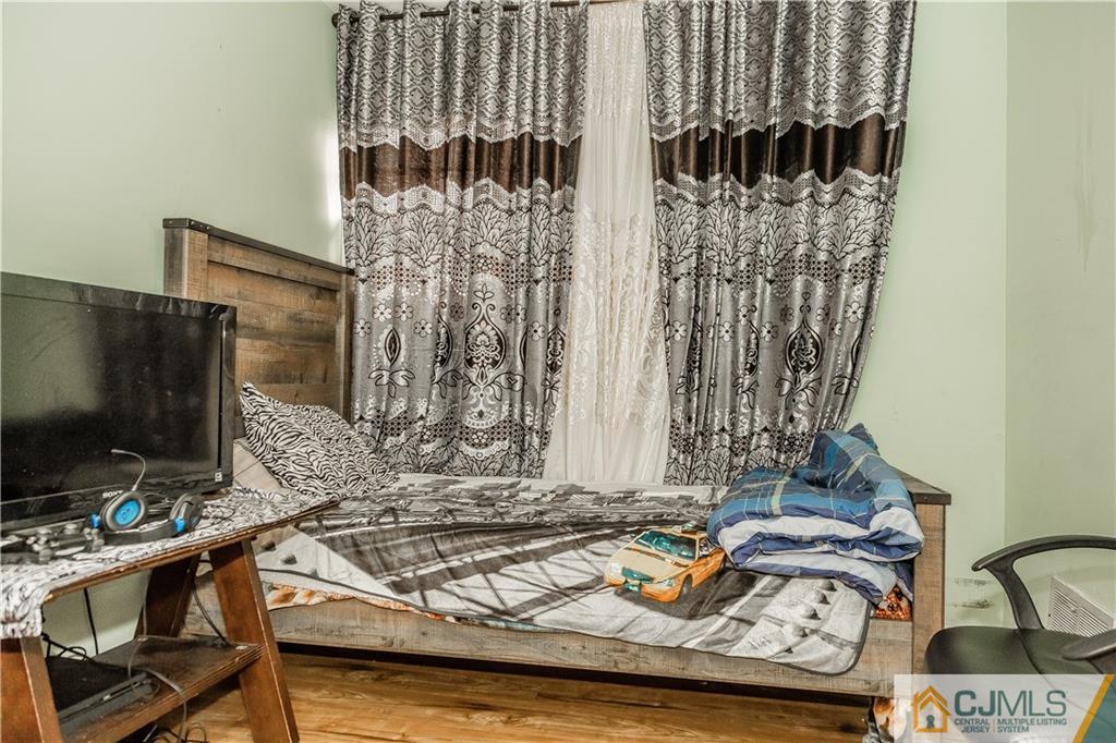 12 Crest Road East Brunswick, NJ 08816 - Photo 18 of 30 a living room with furniture and a flat screen tv