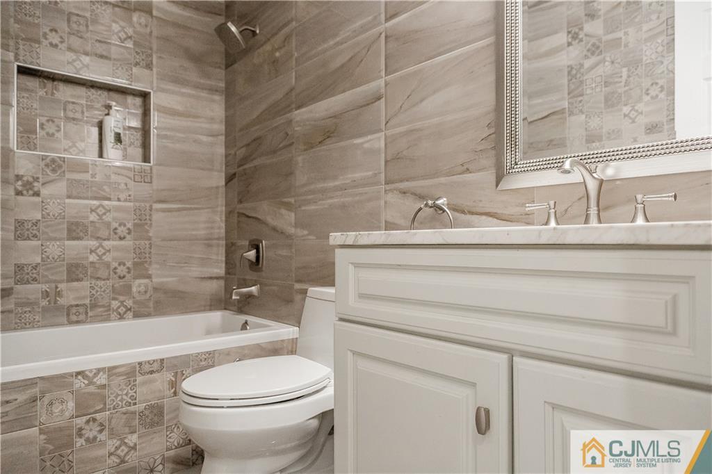 12 Crest Road East Brunswick, NJ 08816 - Photo 19 of 30 a bathroom with a sink a toilet and a bathtub