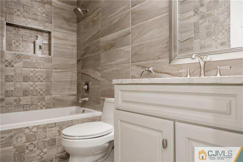 12 Crest Road East Brunswick, NJ 08816 - Photo 20 of 30 a bathroom with a sink a toilet and a bathtub