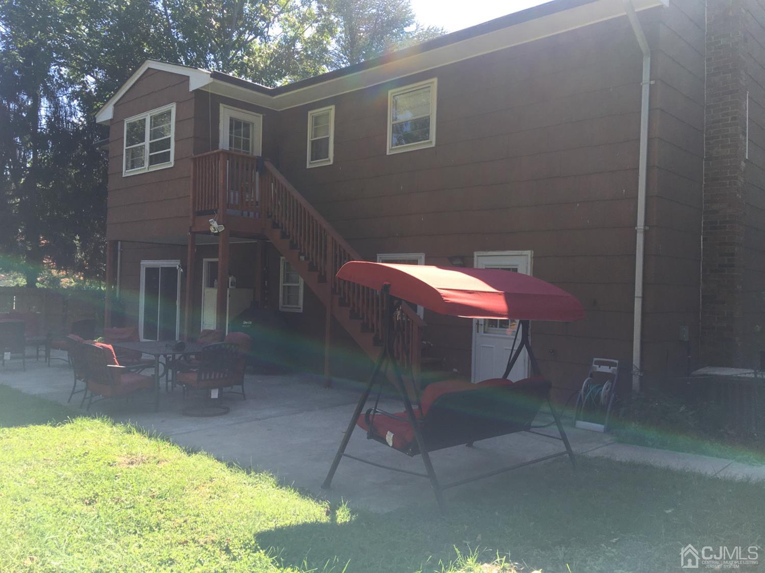 12 Crest Road East Brunswick, NJ 08816 - Photo 28 of 30 a backyard of a house with table and chairs