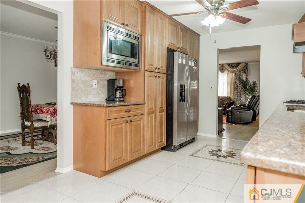 12 Crest Road East Brunswick, NJ 08816 - Photo 5 of 30 a kitchen with stainless steel appliances kitchen island granite countertop a refrigerator and a stove top oven