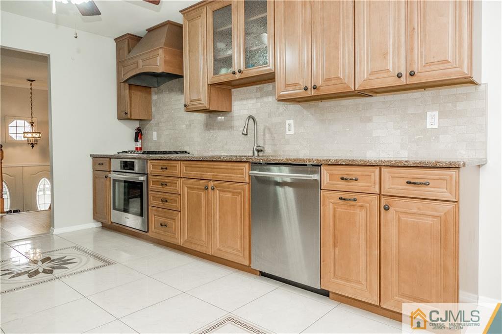 12 Crest Road East Brunswick, NJ 08816 - Photo 8 of 30 a kitchen with stainless steel appliances granite countertop a stove and a white cabinets