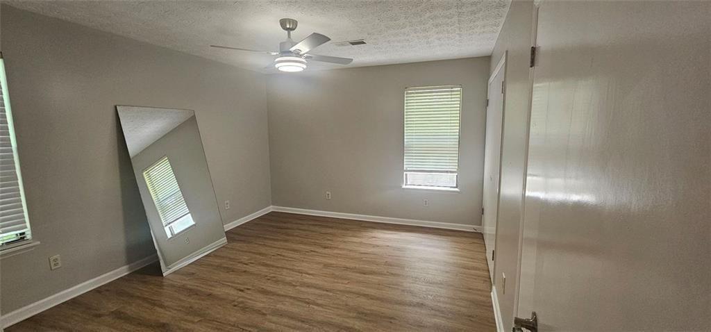 2810 Greenbower Court Atlanta, GA 30349 - Photo 15 of 24 an empty room with wooden floor and a window