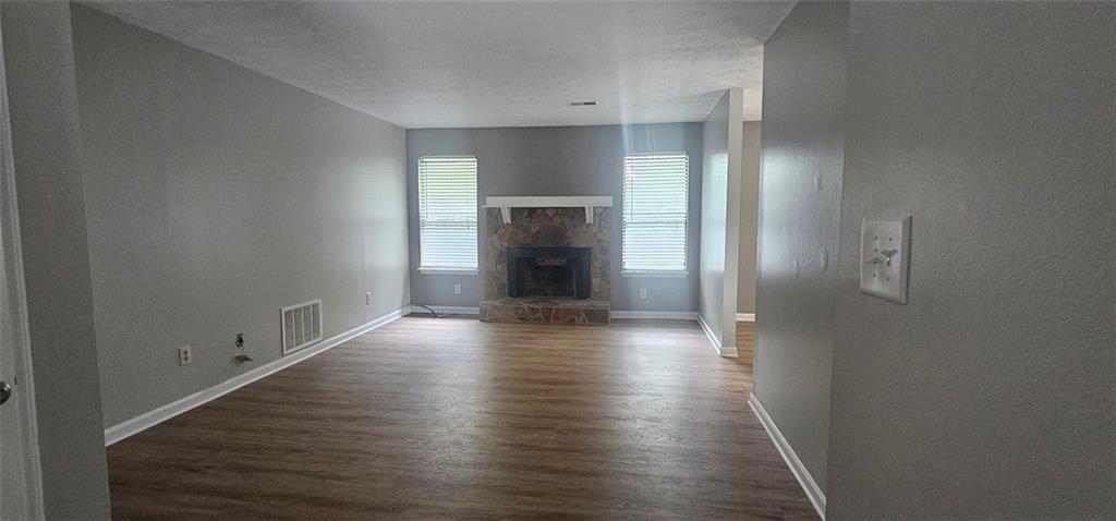 2810 Greenbower Court Atlanta, GA 30349 - Photo 3 of 24 a view of a room with wooden floor and fireplace