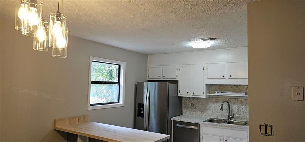 2810 Greenbower Court Atlanta, GA 30349 - Photo 5 of 24 a kitchen with stainless steel appliances granite countertop a refrigerator sink and stove