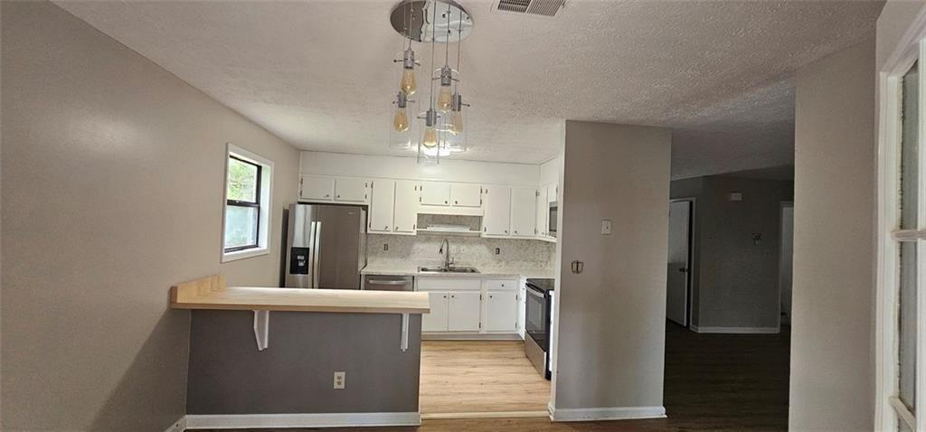 2810 Greenbower Court Atlanta, GA 30349 - Photo 10 of 24 a view of a kitchen with a sink stainless steel appliances and cabinets