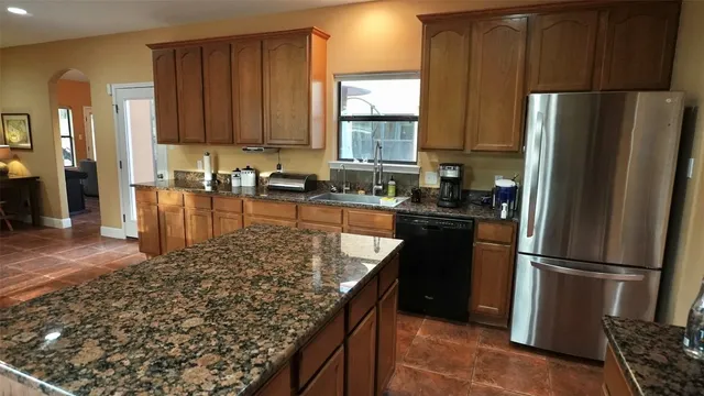 a kitchen with a refrigerator stove and a sink