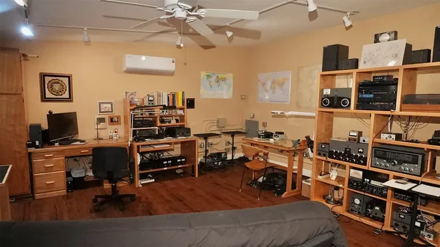 a workspace with furniture wooden floor and a window