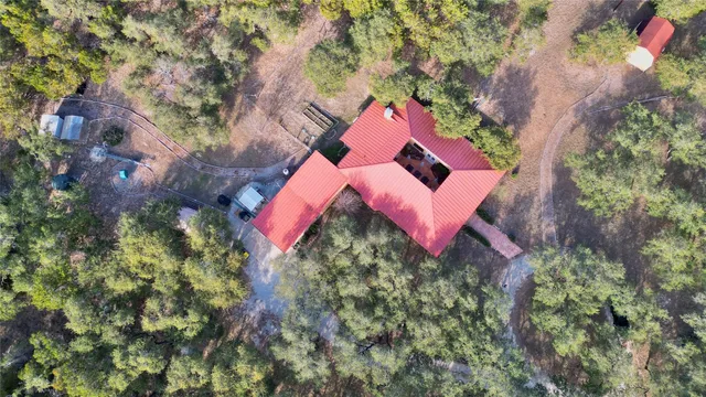 an aerial view of house with yard and outdoor seating